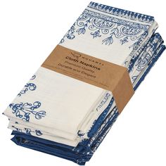 four blue and white napkins stacked on top of each other