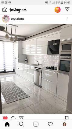 an instagram photo of a white kitchen with stainless steel appliances and tile flooring