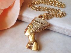 Fascination with ancient Egyptian artifacts profoundly influenced archaeology and popular culture. This is a statement necklace. This striking pendant features a sculpted Egyptian queen Nefertiti, goddess is sculpted on both side. Metal made of pewter and plated in 24 karat gold. Hanging off a gold filled chain. This necklace makes a fabulous layering necklace...  Pendant is 1 inch in length. Goddess is sculpted on both side. Please select with or without chain. Available in silver finish: https Goddess Egyptian, Egyptian Pendant, Egyptian Heritage, Ancient Egyptian Artifacts, Egypt Jewelry, Ancient Egyptian Jewelry, Egyptian Queen Nefertiti, Art Statement, Earthy Jewelry