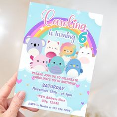 someone holding up a birthday card with cartoon animals and rainbows on it in front of a white background