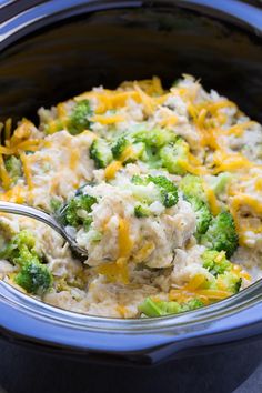 broccoli and chicken casserole in a crock pot with a spoon