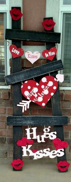 a wooden sign with hearts and kisses on it