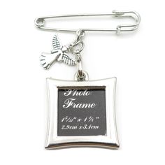 a silver plated metal frame with a cross and angel charm attached to the clasp