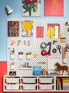 a room with several storage bins and various items on the wall, including an animal figurine