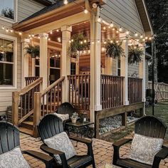 an outdoor patio with chairs and string lights on the front porch, surrounded by brick pavers