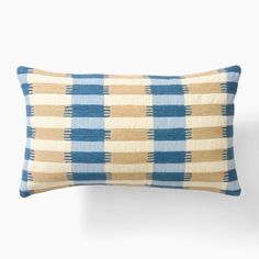 a blue and beige plaid pillow on a white background