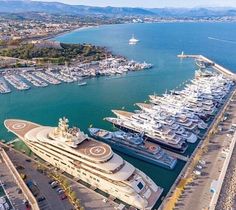 an aerial view of several boats docked in the water