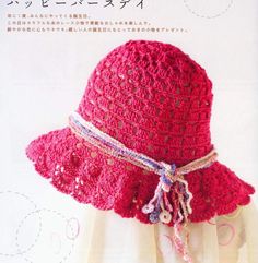 a crocheted pink hat with ribbon around the brim