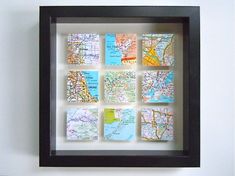 a black frame holds maps and magnets on the wall