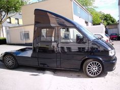 a black van parked in front of a building with its door open and windows closed