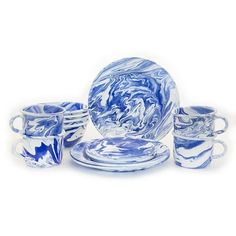 a blue and white dinnerware set with swirl designs