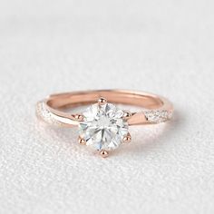 a rose gold engagement ring with a round diamond in the center