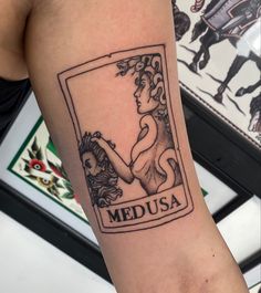 a woman's arm with a medusa tattoo on it