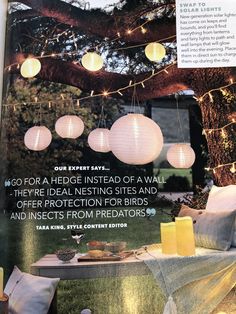 an article in the magazine about hanging paper lanterns and other decorative items on a table