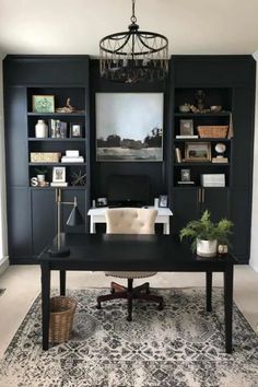 Highlight the elegance of black built-in shelves in your home office and personalize the space with your favorite farmhouse decor. Pair the dark notes with a sleek black desk, complemented by a charming house plant and a white chair tucked underneath. A modern light fixture and a patterned rug seamlessly blend modern and traditional elements for a chic design.