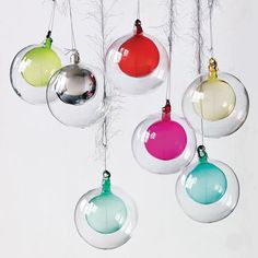 christmas ornaments hanging from strings with colored balls in the middle and one ornament at the bottom