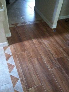 a bathroom with wooden floors and tile flooring