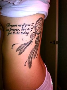 the back of a woman's stomach with a dream catcher tattoo on it