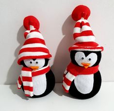 two stuffed penguins wearing hats and scarves