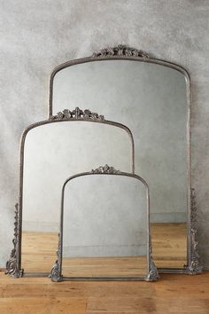 three mirrors sitting on top of a wooden floor