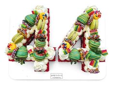 the number forty - four made out of cake is decorated with colorful icing and decorations