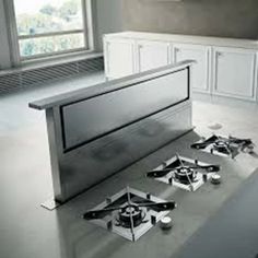 an image of a kitchen setting with stainless steel stove top and burners on the floor