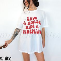 a woman wearing a white t - shirt that says save a horse ride a fireman