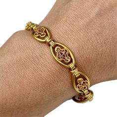 "18K Yellow Gold Ruby Filigree Scrolls Oval Link Bracelet 7.5\" Victorian Revival Openwork three-dimensional floral motifs elaborately crafted in sandblasted matte gold. Textured chunky connectors create lovely contrast. This is a pre-owned item in excellent vintage condition. DETAILS: Weight: 15.0 grams. Measurement: Length: slightly over 7 1/2\"; Width: 10 mm. Marks not legible - as shown." Victorian Revival, Wedding Jewelry Bracelets, Floral Motifs, Wedding Bracelet, Measurement Length, Matte Gold, Floral Motif, Link Bracelets, Three Dimensional