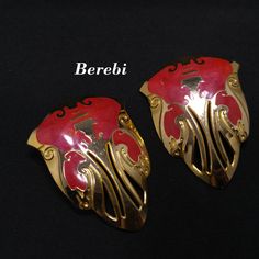 *Description: This is a beautiful pair of Edgar Berebi clip on earrings with red enamel and gold tone openwork design from the 1980s.  The earrings are light in weight and large in size.  This would be a great addition to your vintage jewelry collection or make a great vintage gift! Edgar Berebi's jewelry trademark began in 1979 and ended in 2001. Produced in limited edition, his designs are highly collectible. Berebi graduated from the Pratt Institute of Art, Design and Architecture. After grad Jewelry Boards, Filigree Design, 1980s Vintage, Large Earrings, Jewelry Companies, Vintage Gifts, Clip On Earrings, Beautiful Necklaces, Hippie Boho