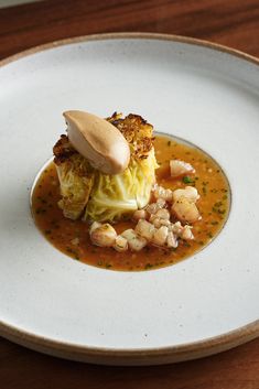 a white plate topped with food on top of a wooden table