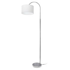 a floor lamp with a white shade on the base and a round light fixture in front of it