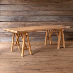 a wooden bench sitting on top of a hard wood floor next to a wooden wall