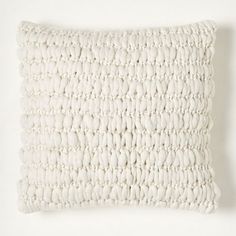 a white pillow on a white wall