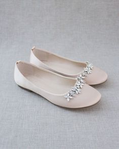 Inspired by a contemporary and refined designed ballet flat. This smooth satin round toe flat adorned with a sparkly floral embellishment brings a comfortable simplicity for fall or summer wedding, bridesmaids, bridal party, holiday party, and any special occasions.. The light blue color can easily be your something blue. Perfect mix of traditional elegance with a touch of dazzle. Pair with a matching clutch to complement your look. DETAILS: COLORS AVAILABLE: White, Ivory, Light Blue, Black, Burgundy, Navy, Hunter Green, Champagne, Dusty Pink UPPER: Synthetic upper and lining MATERIALS: Manmade outsole STYLE NAME: CASSIE Not sure of which size to purchase? Shoes measurements are as follow: (Please note measurements taken the length of inside of shoe from toe to heel) WOMEN SIZE: Size 5.5: Bridesmaid Shoes Flat, Classic Wedding Shoes, Fall Wedding Shoes, Champagne Shoes, Bride Heels, Ivory Bridal Shoes, Floral Embellishment, Holiday Shoes, Evening Flats