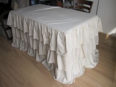 the table is covered with white ruffled cloth