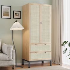 a living room with a couch and a tall cabinet in the corner next to a lamp