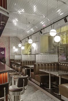 the interior of a restaurant with leather booths and bar stools in front of them