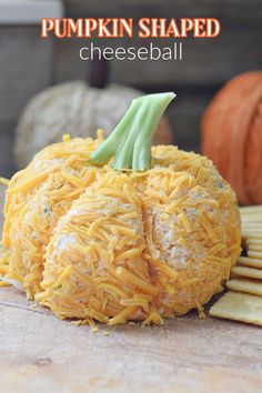 a pumpkin shaped cheeseball on top of crackers