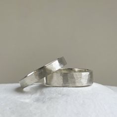 two silver rings sitting on top of each other