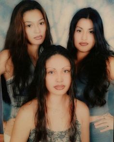 three young women are posing for a photo