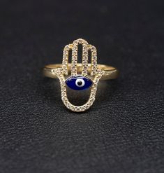 "14k Real Solid Yellow Gold Hamsa Hand Evil Eye  Ring, 14k Solid Gold Women Dainty Ring, Evil Eye Gold Ring for Women, Hamsa Hand Gold Ring, Minimalist Ring * Metal : Real 14K Yellow Gold, (Properly Stamped, 14K) * Condition : Brand New * Finish : Polished * Band thickness:2.4 mm  * Hamsa Hand Size: 18 mm length, 13mm width * Scale: : 6,5US, 7US, 7.5US, 8US, 8.5US * Stone: Cubic Zirconia These Rings are 100% Authentic 14K Solid Real Gold .  \"Not Plated or Filled\" This is a Beautiful Genuine Real 14K Solid Gold  Hamsa Hand With Evil Eye Ring BOSPHORUSGOLD" Evil Eye Gold Ring, Evil Eye Ring Gold, Evil Eye Art, Hand Evil Eye, Gold Ring For Women, Diamond Wallpaper, Evil Eye Design, Gold Hamsa, Gold Jewelry Stores