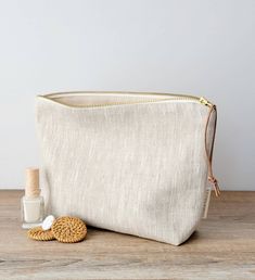 Hello!         Are you looking for a very unique handmade gift for women? ( or for yourself ! )  If yes, this is THE ONE !         This feminine linen pouch  is made in a beautiful  natural linen / cotton canva.  It will become her favorite makeup bag to carry her little needs ; cosmetics, makeup, lip balm, beauty products, skin care products, personnal stuff and more. It could be used as a travel pouch too. The neutral solid pattern is loved from every taste -Earthy and Casual Style-  it fits every women.  Carefully handcrafted, High quality fabric at  a good price.  Win-Win !  For you, Who is this Special woman who will be happy to receive it? Your grilfriend, mother, wife, sister, niece ? About your mother-in-law ? ( she will be impressed for sure ;)) You choose. SPEC: . Handmade by Cou Beige Makeup, Tampax Pearl, Linen Pouch, Toiletry Bag Women, Canvas Bag Design, Large Makeup Bag, Pouch Makeup, Favorite Makeup, Women Cosmetics