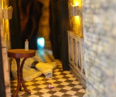 there is a small table with a candle on it in front of a door way