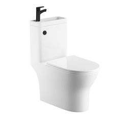 a white toilet sitting next to a wall mounted faucet