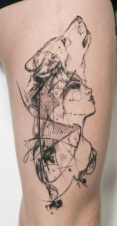 a woman's thigh with an abstract wolf tattoo on it, and her head in the background