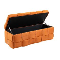 an orange leather storage box with black linings on the bottom and sides, open