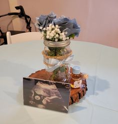 there is a vase with flowers in it on top of a table next to an album