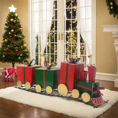 a christmas train with presents in front of a window