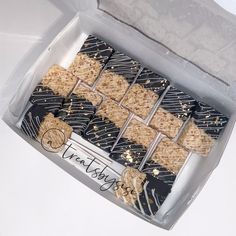 an open box of cookies with gold sprinkles