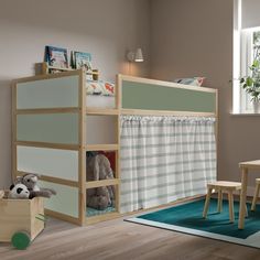 a child's bedroom with a bunk bed, table and chairs